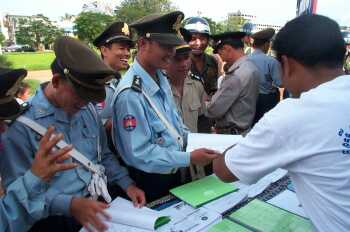 Policeman looking at sign language books